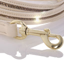 Close-up of a white handbag with gold hardware on a white background