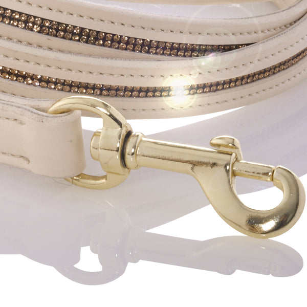 Close-up of a white handbag with gold hardware on a white background