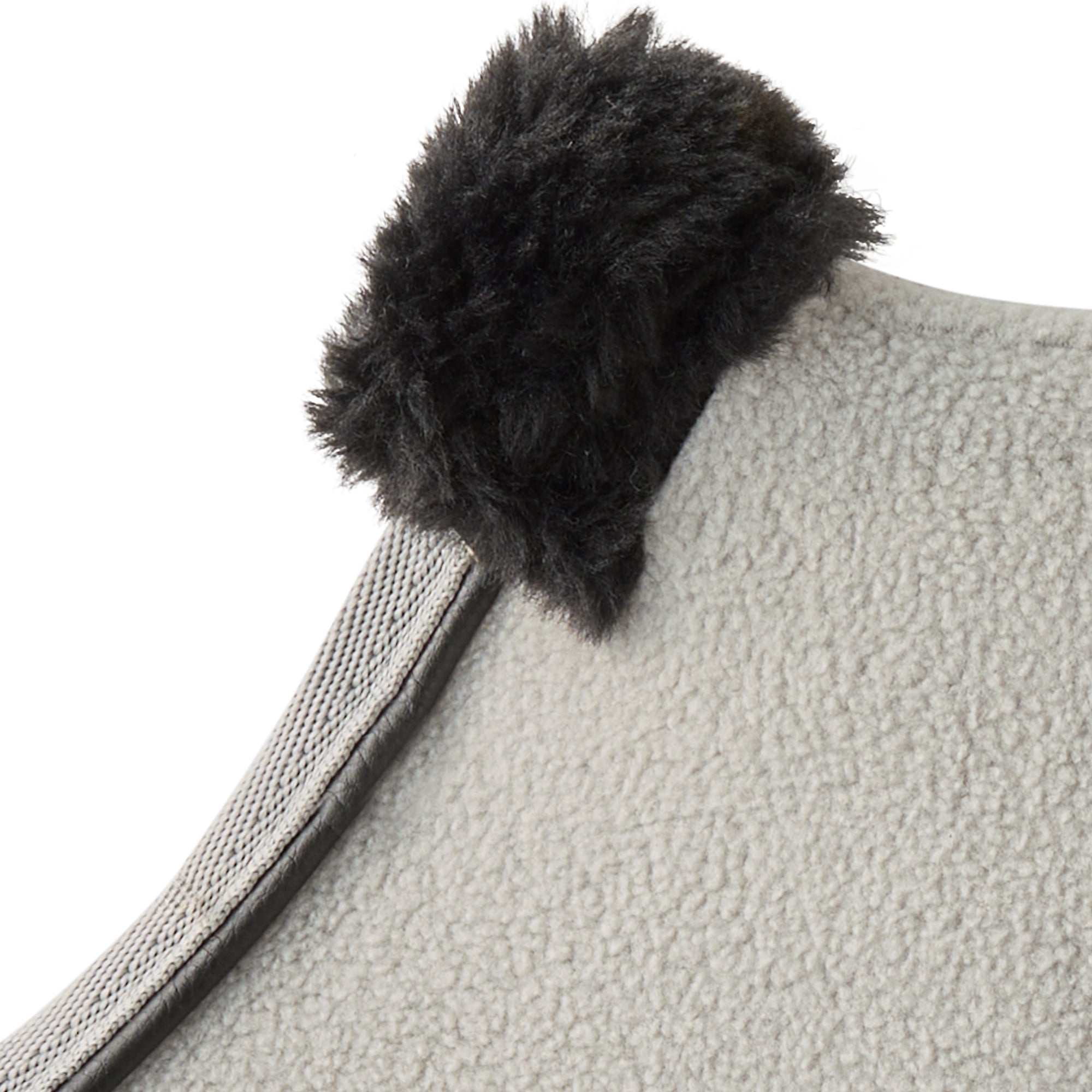 Gray textured fabric with a black fluffy pom-pom on a white background