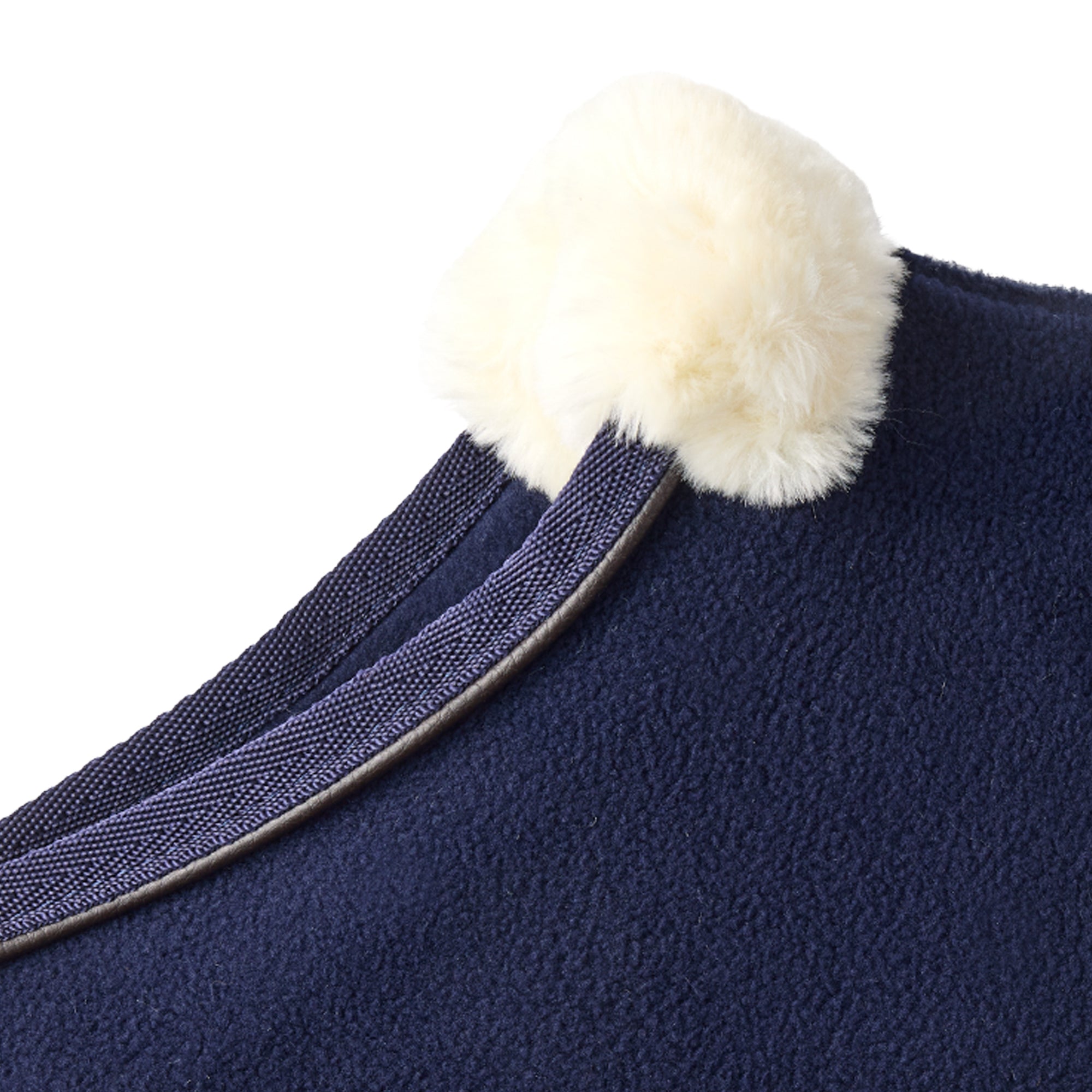 Navy blue fabric with a white pom-pom on a white background