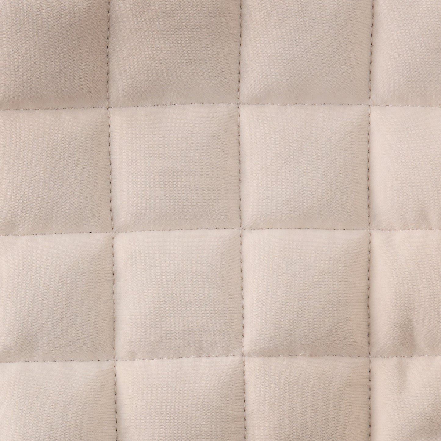 Close-up of a quilted beige fabric texture