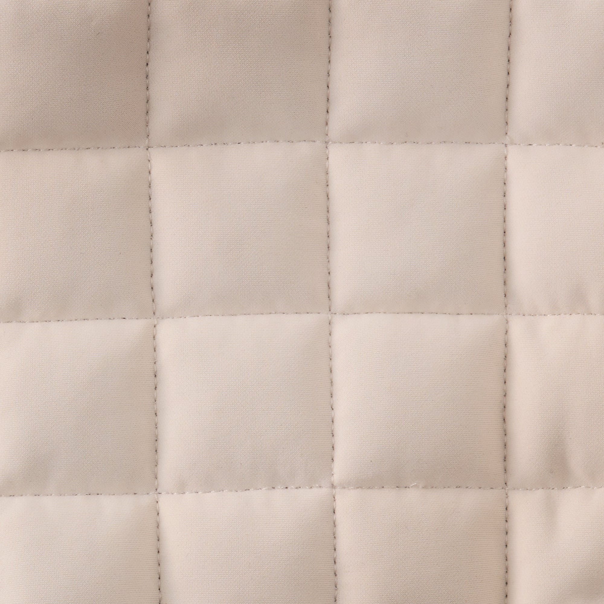 Close-up of a quilted beige fabric texture