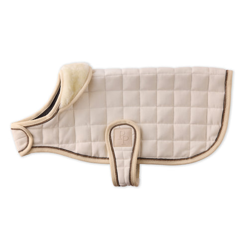 Beige quilted saddle pad with brown trim on a white background