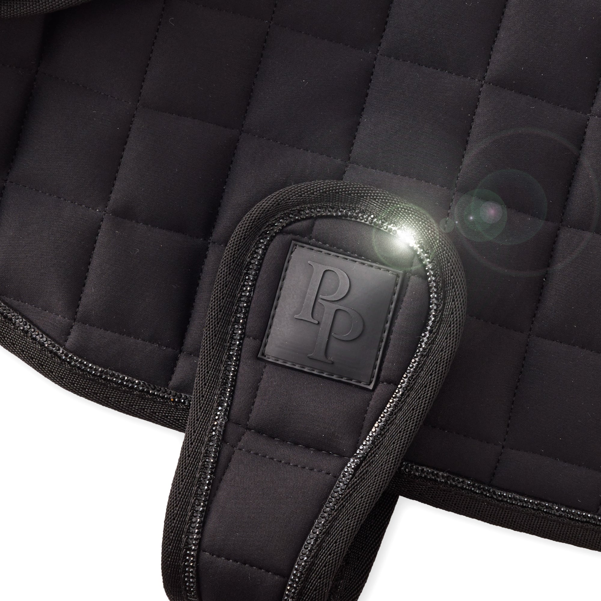 Black quilted saddle pad with a brand logo on a white background