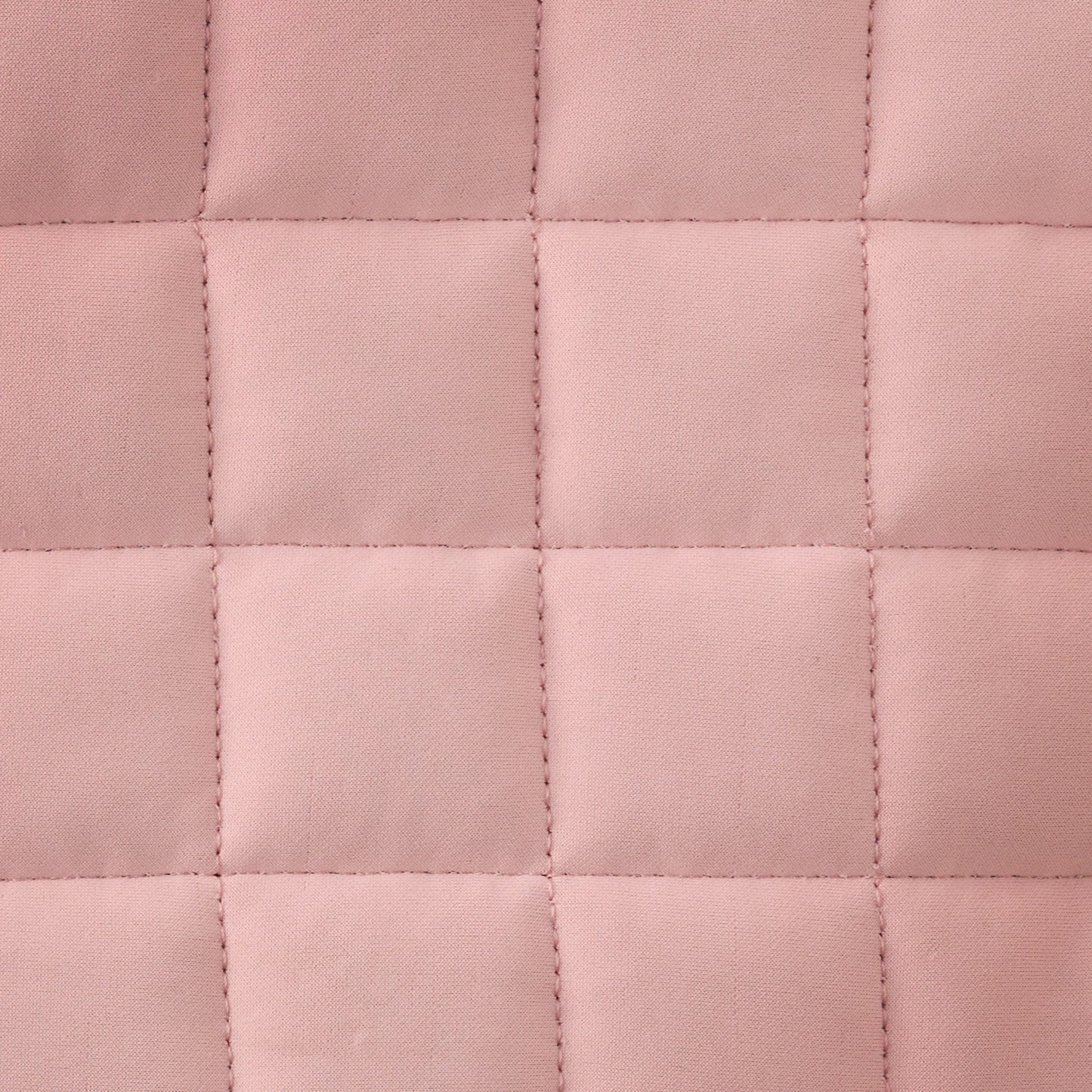 Close-up of a pink quilted fabric texture