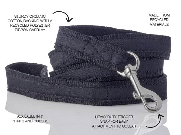 Navy dog leash with silver trigger snap on a white background, featuring text about material and features.