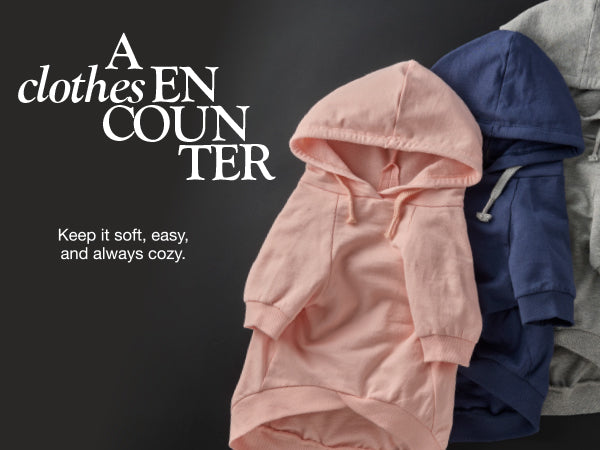 Pink hoodie with other jackets on a black background, featuring text about clothing.