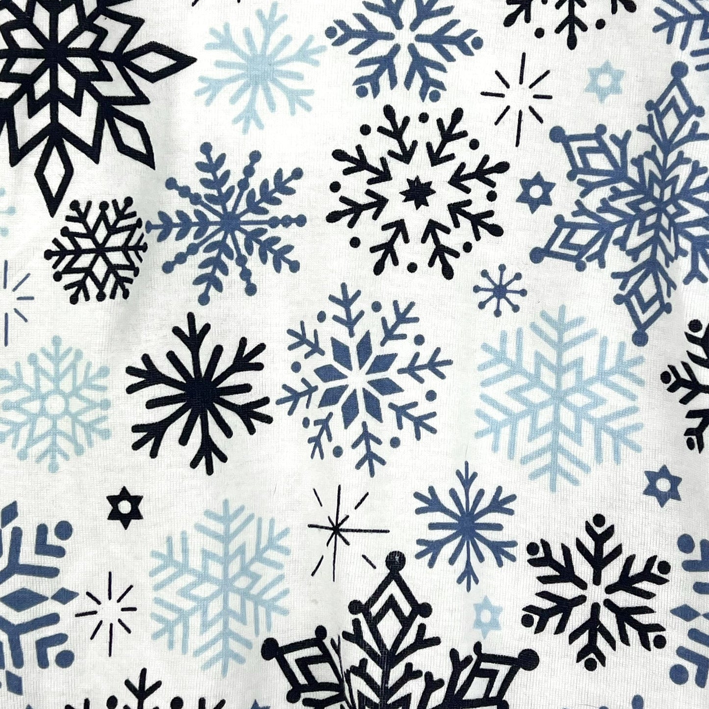 Pattern of black and blue snowflakes on a white background