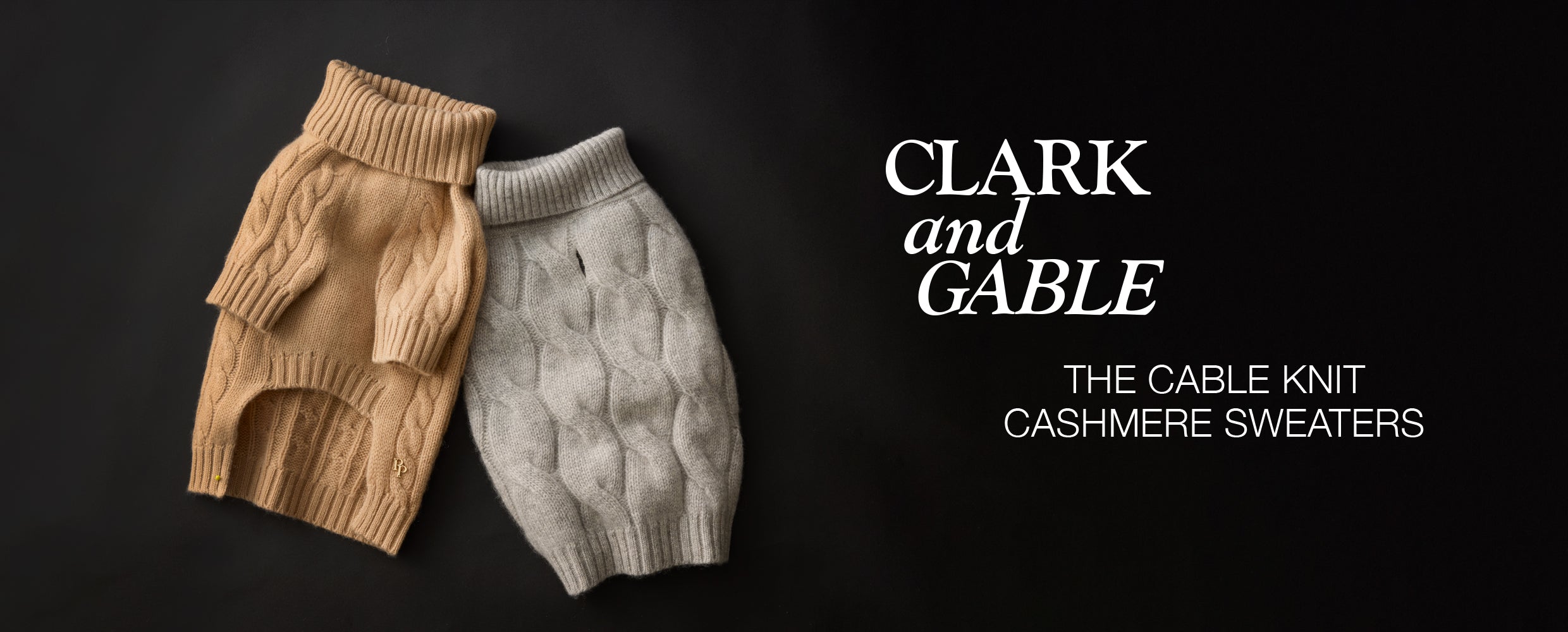 Two cable knit cashmere sweaters, one beige and one gray, on a black background with 'Clark and Gable' branding.