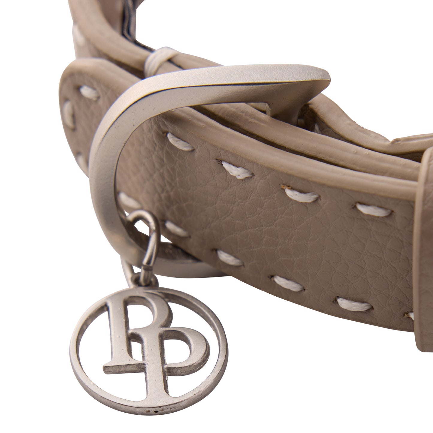 Close up of collar hardware and pet passion key chain on a white background