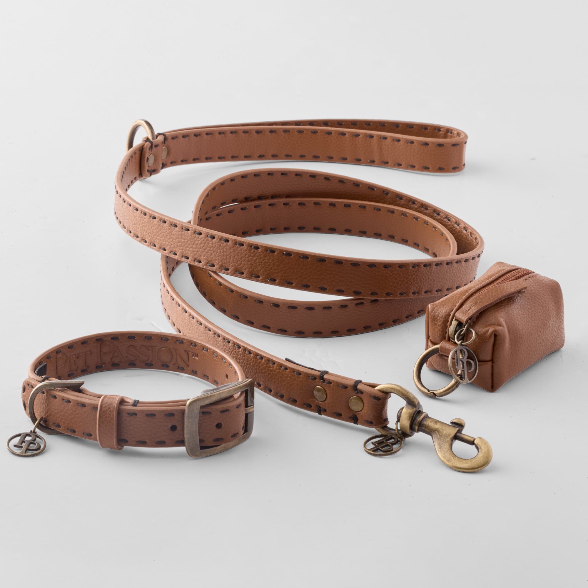 Layout of Rein collection including the Leash, Collar, and Caddy Bag in Chestnut Hunter