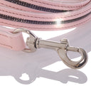 Close-up of a pink dog leash with a silver clasp on a white background