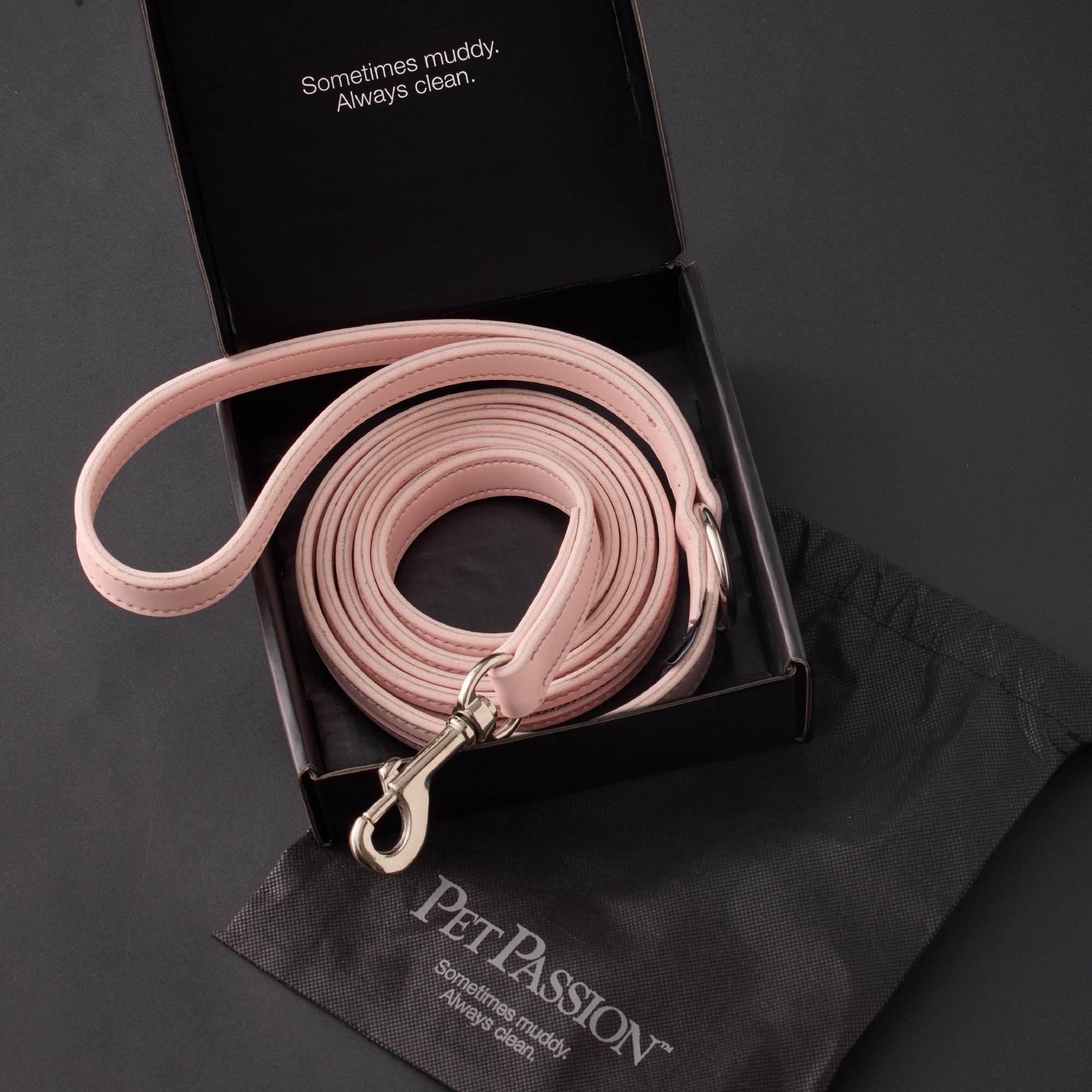 Pink dog leash in a black box with 'Pet Passion' branding on a dark background