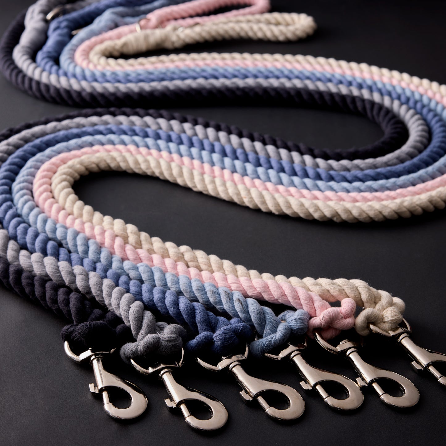 Display of all the twisted rope leashes on a black background 
