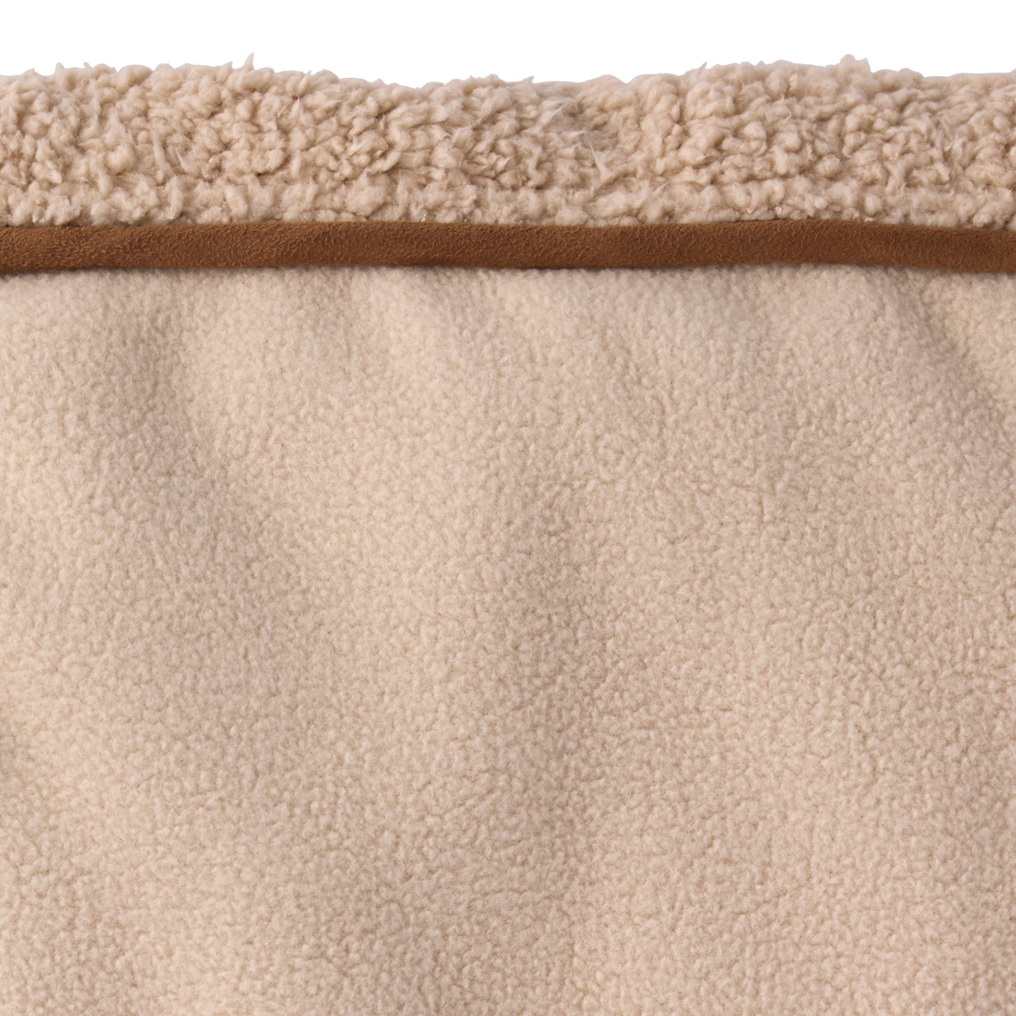 Close-up of a textured beige surface with a brown border