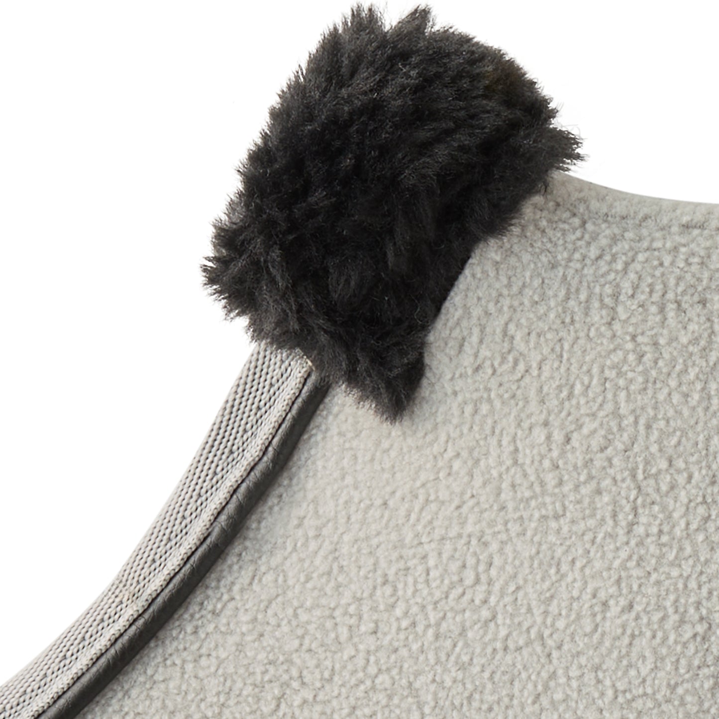 Gray textured fabric with a black fluffy pom-pom on a white background