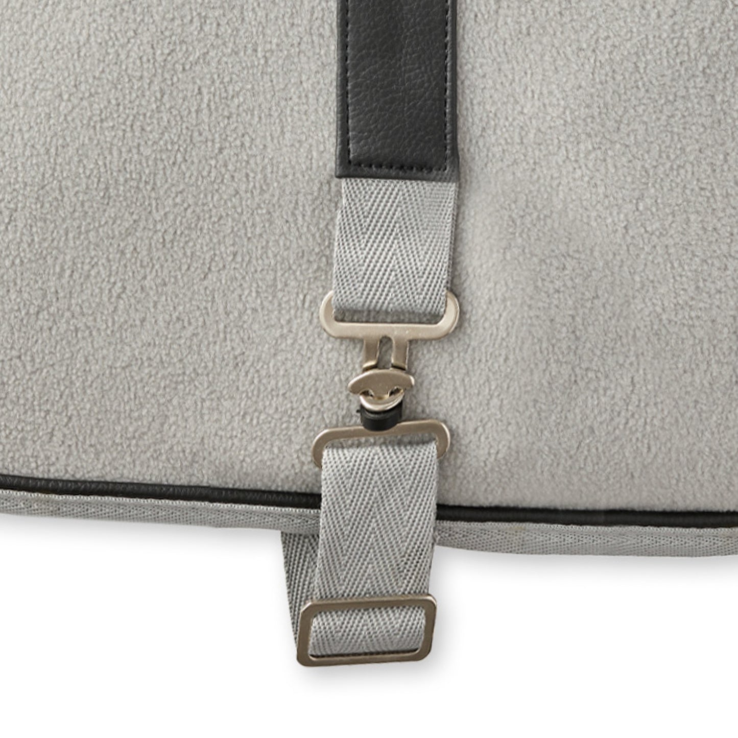 Close-up of a gray dog coat with a strap and buckle on a white background