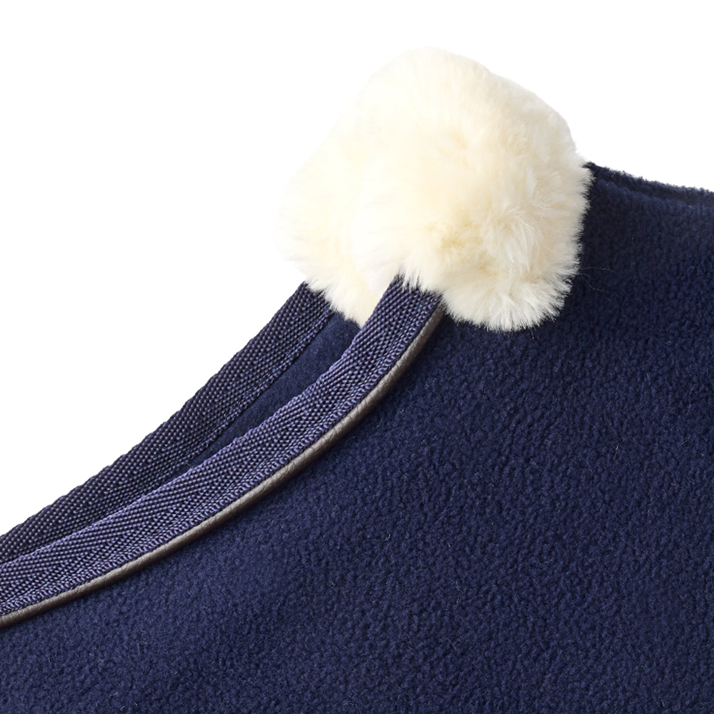 Navy blue fabric with a white pom-pom on a white background