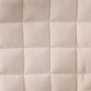 Close-up of a quilted beige fabric texture