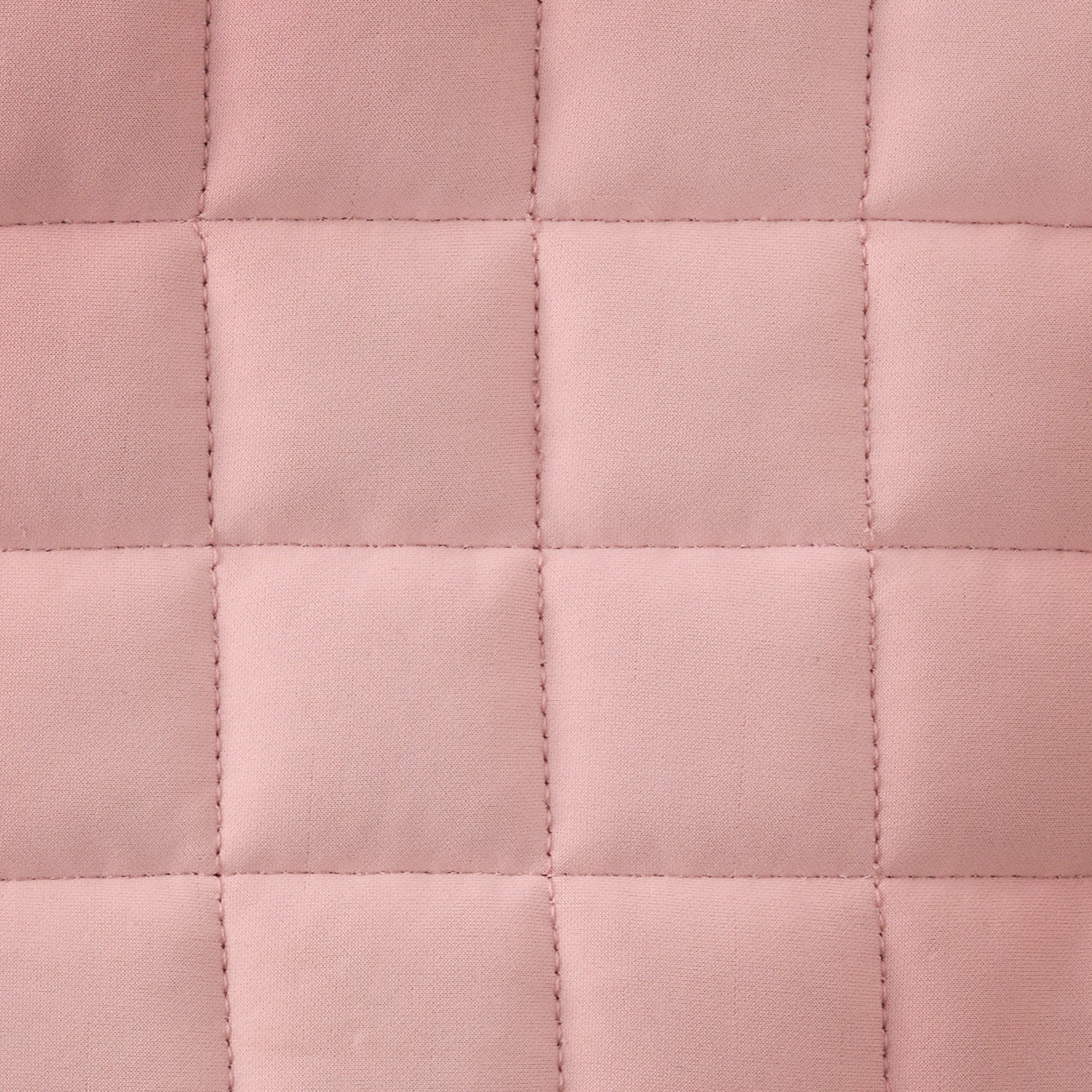 Close-up of a pink quilted fabric texture
