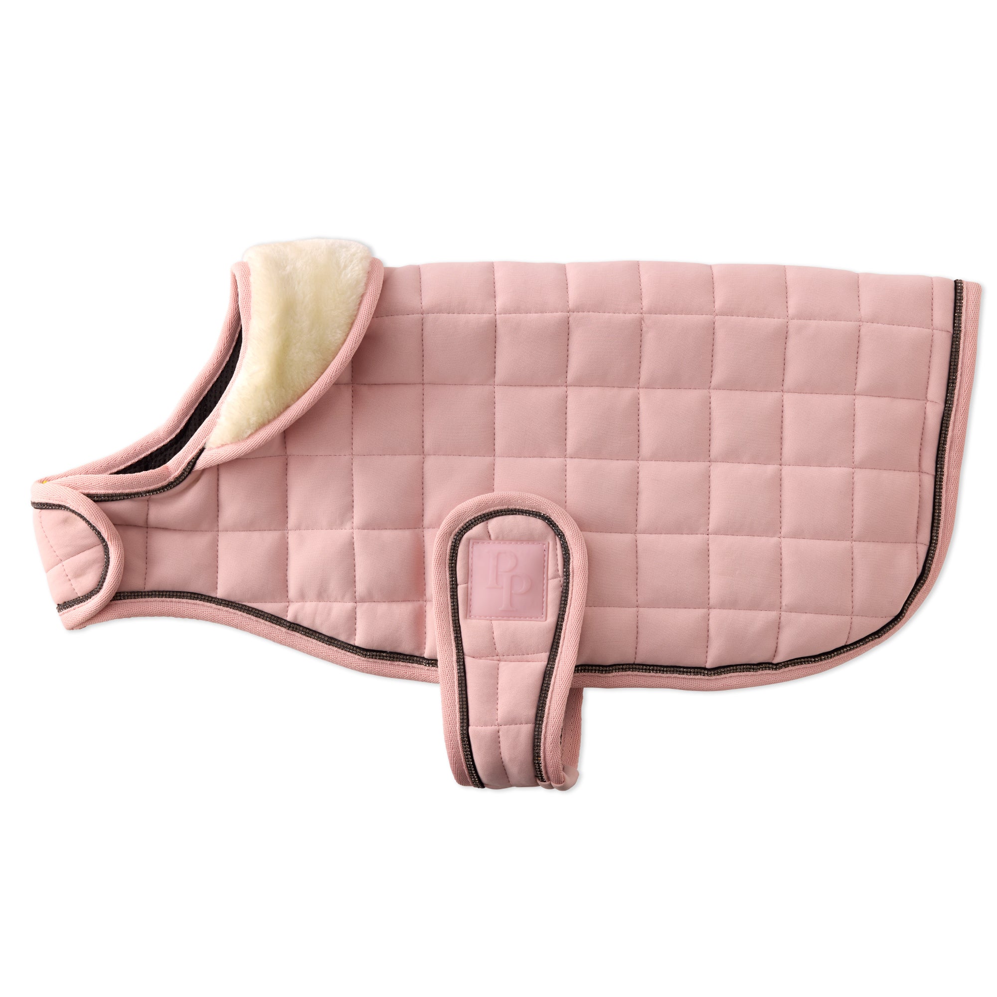 Pink quilted saddle pad with beige interior on a white background