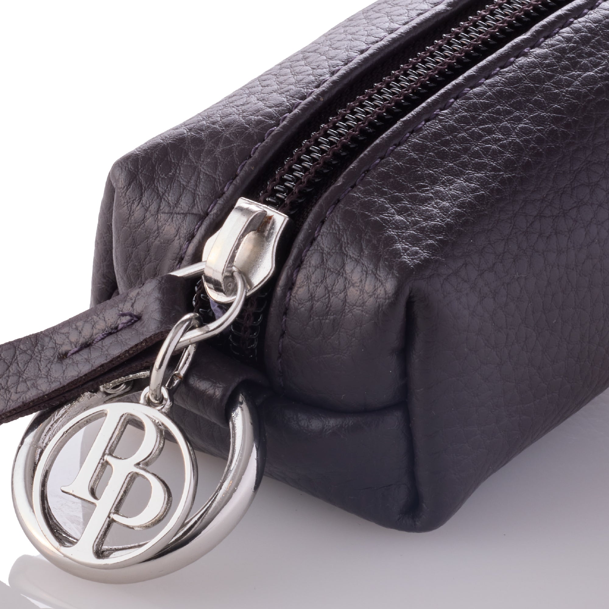 Closeup of the zipper hardware and Pet  Passion key chain on the Caddy
