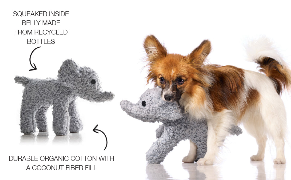 Dog playing with a gray elephant-shaped toy, with text about the toy's materials on a white background.