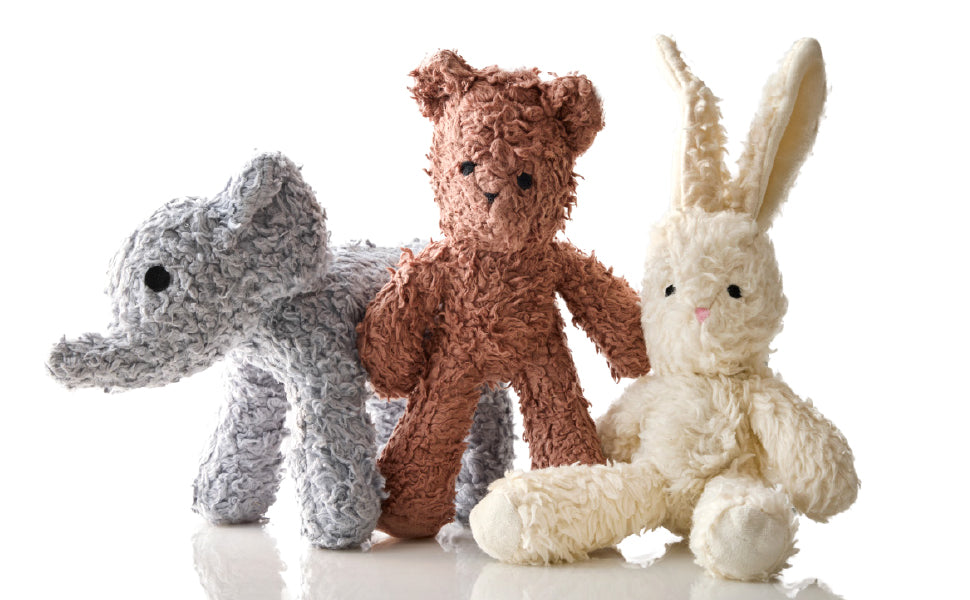Three knitted toys: an elephant, a bear, and a rabbit, on a white background.
